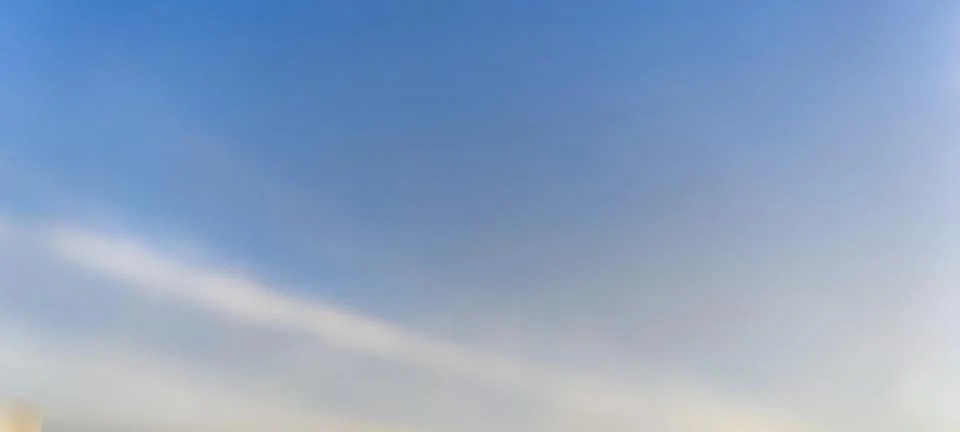 White translucent clouds against the blue sky. Stock Photos