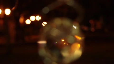 White transparent crystal inside golden spiral wire turning, car passing on back Stock Footage 57463502
