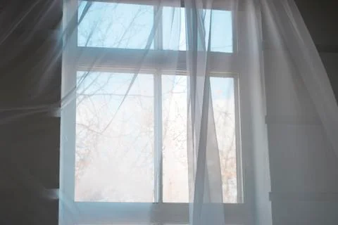 White transparent curtains on the window with spring blue sky Stock Photos