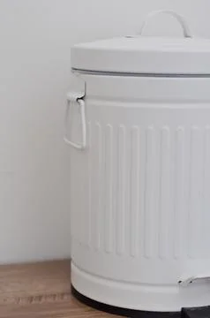 White trash can with copy space on white wall. trash bin Stock Photos