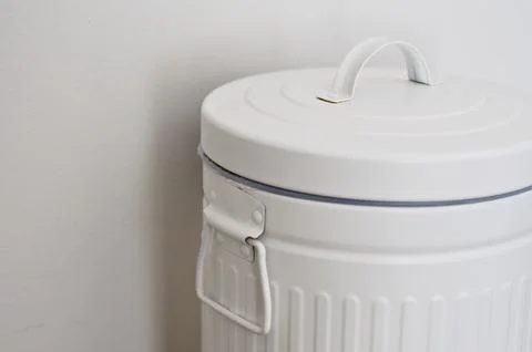 White trash can with copy space on white wall. trash bin Stock Photos