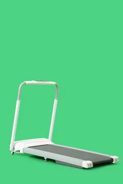 White treadmill on green background Stock Photos