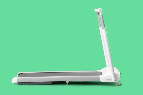White treadmill on green background Stock Photos