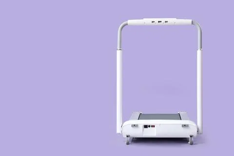 White treadmill on lilac background Stock Photos