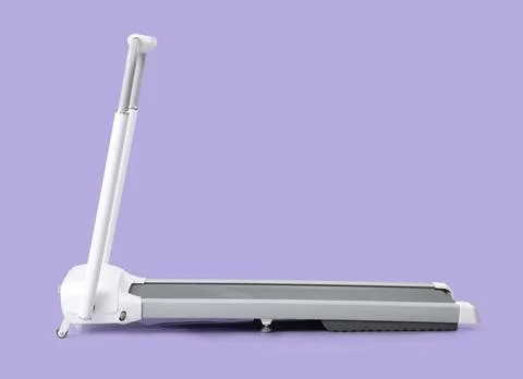 White treadmill on lilac background Stock Photos