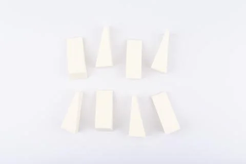 White triangle shaped make up sponges on white background Stock Photos