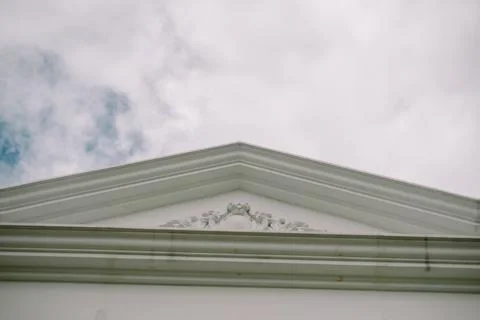White triangular pediment with ornate details 스톡 사진