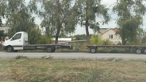White truck and empty trailer beside a road Stock Footage 346410103