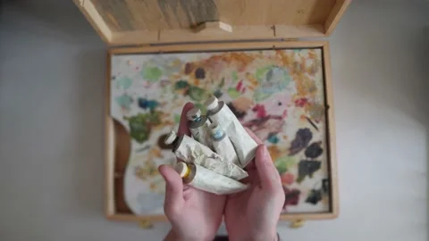 White tubes of paint are placed on the palette Stock Footage 169835135