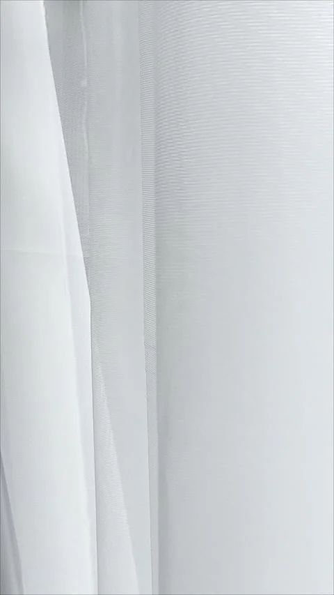 The white tulle hanging on the window is swaying in the wind. Stock Footage 311799210