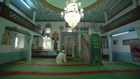 White turbaned imam stands inside small historic wooden mosque - Imam Standing Stock Footage 340524486