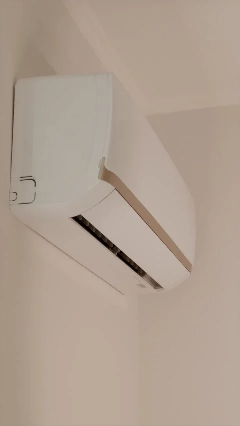 White turned off air conditioner on wall with sunlight moving over unit Stock Footage 346903324