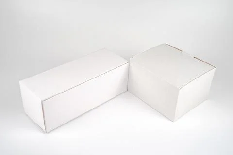 White two paper boxes - tall and fat lay on the white background in studio .. Stock Photos
