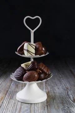 White two tier serving tray full of sweet confectionery with chocolates Stock Photos