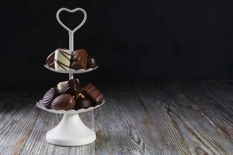 White two tier serving tray full of sweet confectionery with chocolates Stock Photos