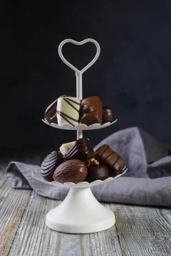 White two tier serving tray full of sweet confectionery with chocolates Stock Photos