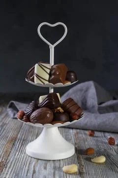 White two tier serving tray full of sweet confectionery with chocolates Stock Photos