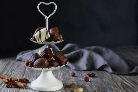 White two tier serving tray full of sweet confectionery with chocolates Stock Photos