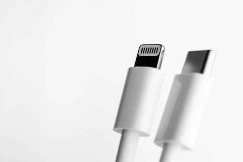 White Type-C cable and lightning, close-up on a white background Stock Photos