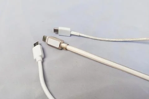 White Type-C charging cable, white background. Stock Photos