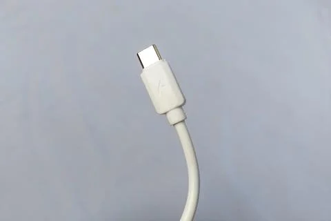 White Type-C charging cable, white background. Stock Photos