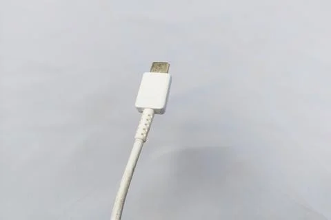 White Type-C charging cable, white background. Stock Photos
