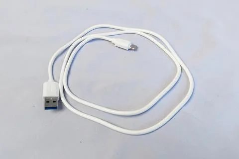 White Type-C charging cable, white background. Stock Photos