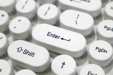 A white typewriter style mechanical keyboard with Enter and Shift keys Stock Photos