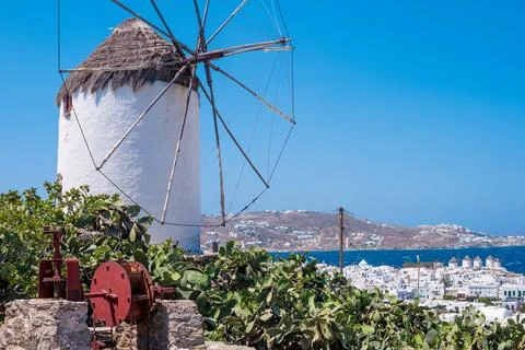 White typical greek windmill on the hill Stock Photos