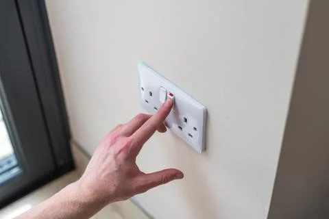 White Uk plug sockets being turned off to save electricity and money for the hou Stock Photos