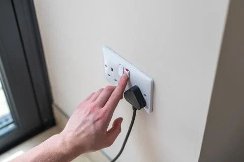 White Uk plug sockets being turned off to save electricity and money for the hou Stock Photos
