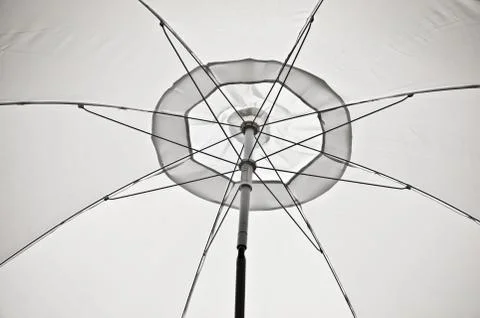 White umbrella in a beach Stock Photos