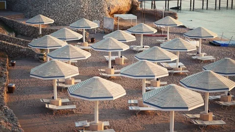 White umbrellas on the beach on the coast of the Red Sea In Sharm El Sheikh, Stock Footage 100839770