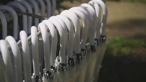 White umbrellas in a folded willow hang in the park Stock Footage 154658228
