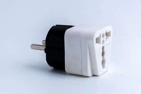 White universal electrical plug adapter isolated on a white background Stock Photos