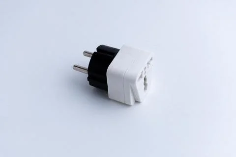 White universal electrical plug adapter isolated on a white background Stock Photos