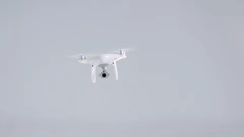 White unmanned quadrocopter drone with camera flying move from left to right Stock Footage 101979858