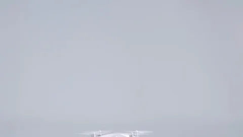 White unmanned wireless quadcopter drone with action camera flying rising up and Stock Footage 126436730
