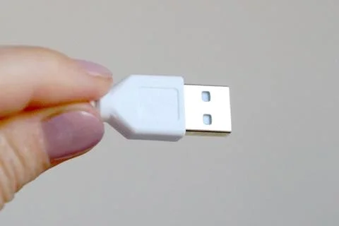 White usb cable in hand close up Stock Photos