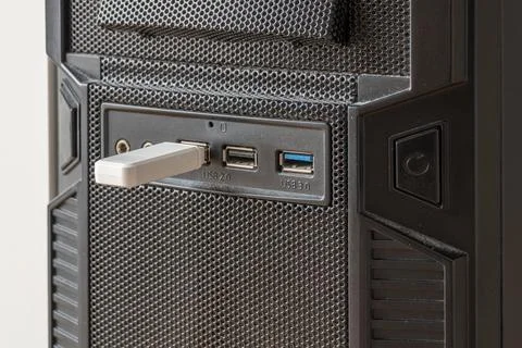 White usb flash drive plugged into computer front panel port on desk Stock Photos