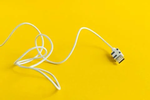 White USB Micro cable isolated on yellow background Stock Photos