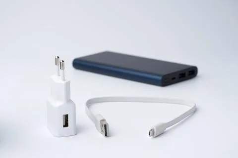 White USB power adapter, cable and blue power bank for divice Stock Photos