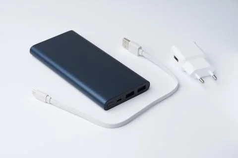 White USB power adapter, cable and blue power bank for divice Stock Photos