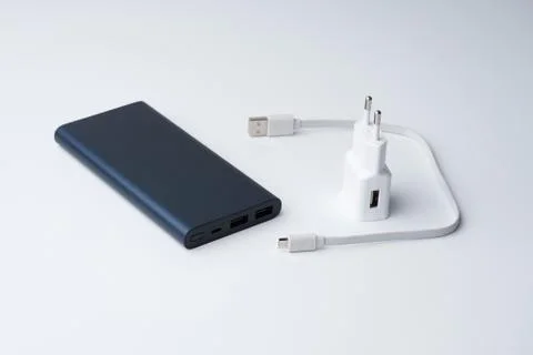 White USB power adapter, cable and blue power bank for divice Stock Photos