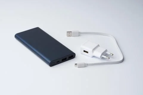 White USB power adapter, cable and blue power bank for divice Stock Photos