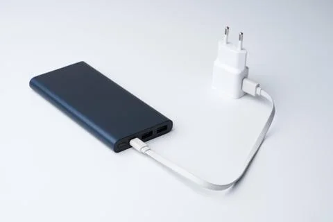 White USB power adapter, cable and blue power bank Stock Photos