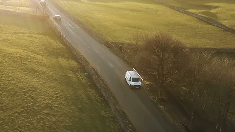 White van aerial tracking shot at sunset through beautiful countryside Stock Footage 105311351
