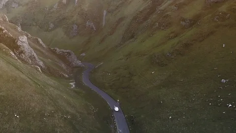 White van aerial tracking shot at sunset through beautiful valley Stock Footage 105311742