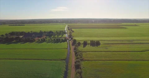 A white van drives towards a drone while tilts down on a small road Video stock 63613649