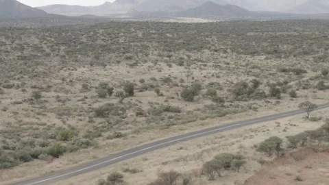 White van driving along single road in rural Namibia 스톡 동영상 244706532